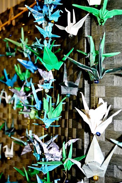 Finished crane-chains hanging on a screen as our photobooth backdrop