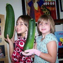 The girls show off zucchini from our first garden.