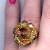 This ring features a very large, very rare, vintage Swarovski crystal surrounded by contemporary firepolished glass beads and Japanese delica seed beads, all hand wired onto a ring base with a perforated top component made specifically for cage work This ring features a very large, very rare, vintage Swarovski crystal surrounded by contemporary firepolished glass beads and Japanese delica seed beads, all hand wired onto a ring base with a perforated top component made specifically for cage work