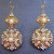 Sophisticated earrings commissioned by a mother of the bride. Hand embroidered pearls, seed pearls and Swarovski crystals on brass filigree stampings. Sophisticated earrings commissioned by a mother of the bride. Hand embroidered pearls, seed pearls and Swarovski crystals on brass filigree stampings.
