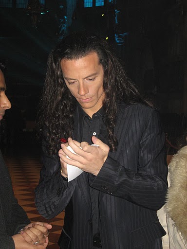 Providing his autograph to a fan