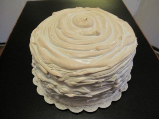 5 layers of swirled white cake &amp; lemon cake with lemon curd between each layer then covered in a swiss lemon meringue