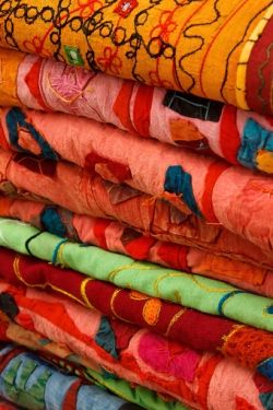 Colorful Fabrics Stacked by Vera Kratochvil at www.publicdomainpictures.net
