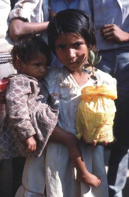 A girl with a tree sapling at the mela