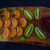 Fruit selection on a wooden platter, kiwis, grapes,clementines and quality chocolate pieces