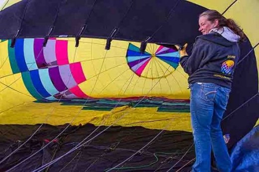The balloon is partially inflated with a powerful fan