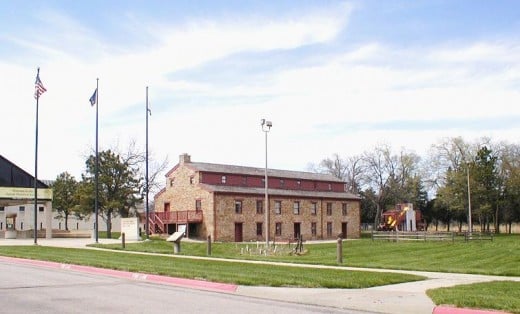 The bright yellow thing toward the right is a plastic playground slide which IMHO is totally out of place so close to a 100-some year old building from Territorial Kansas.