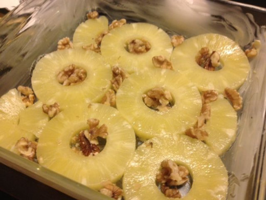 Place the almond halves inside the centers of the pineapple rings and use the rest to fill in the gaps.