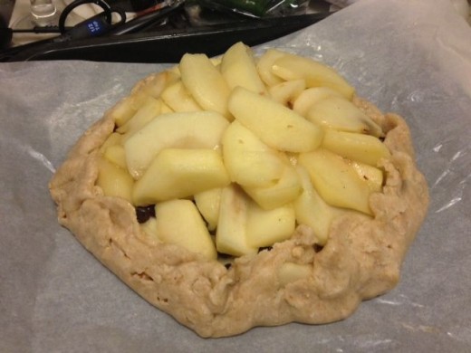 Carefully gather the ends and bring them over the apples. If it tears just press the dough together.