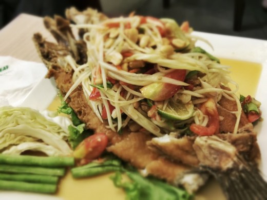 Deep fried whole fish with spicy papaya salad. The oils in the fish tempered the flames of the chili. Delicious.