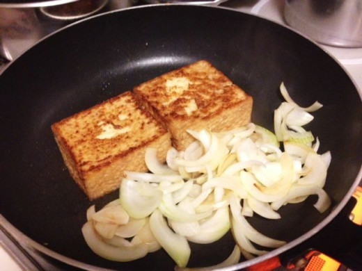 Cook the tofu until nicely brown on both sides. If you have room, you can sauté the onions on the side while the tofu is cooking as I did.