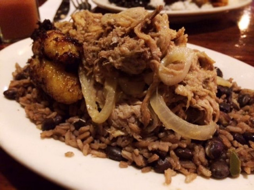 Ropa Vieja, roast hand-pulled pork sauteed with onions, served with arroz moro and platanos maduros. LOVE!