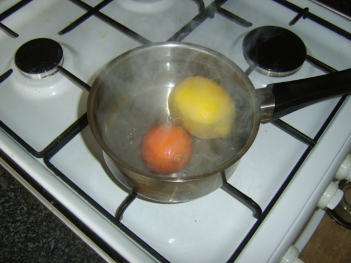 Lemon and orange are heated in boiling water