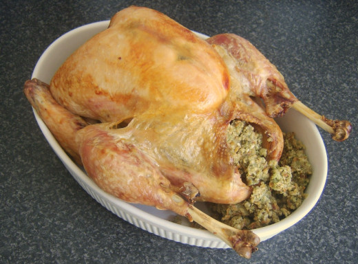 Stuffing is arranged in and around the roast turkey