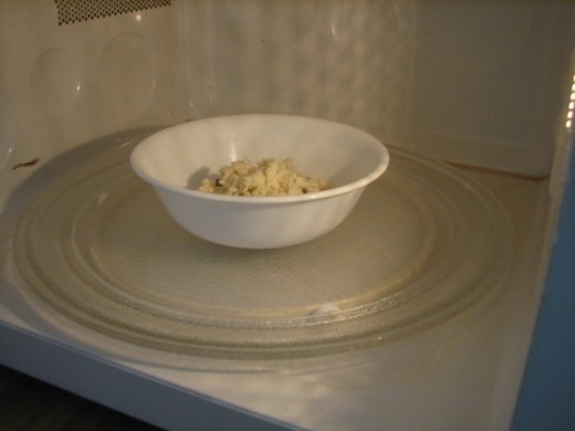 place the dish of meat and cheese inside your microwave oven, you might want to cover this to reduce splattering