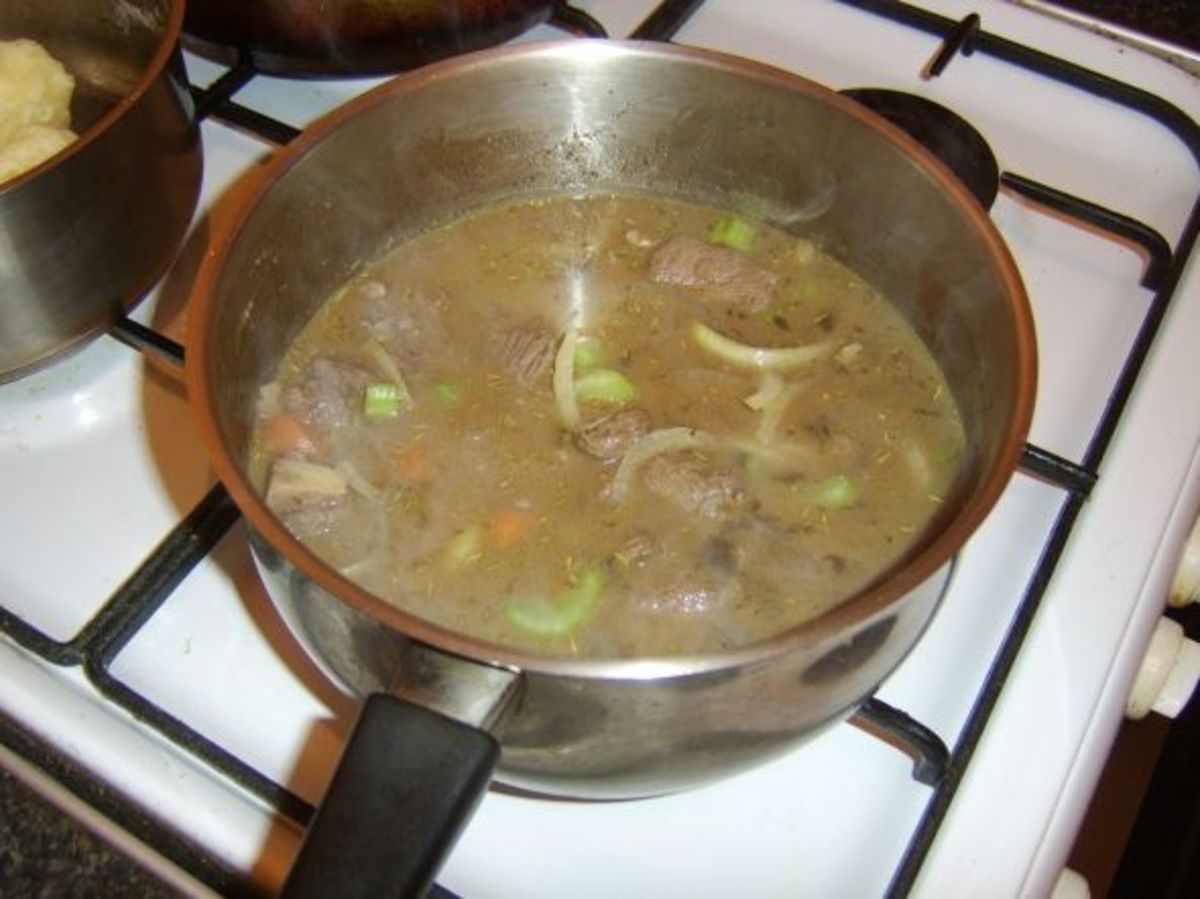 Stock is added to the venison and brought to a simmer