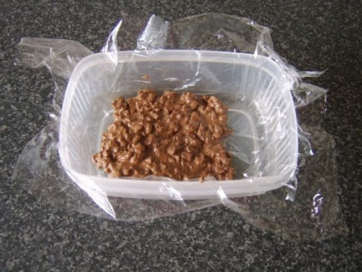 Chocolate and walnut crunch is spread out to set