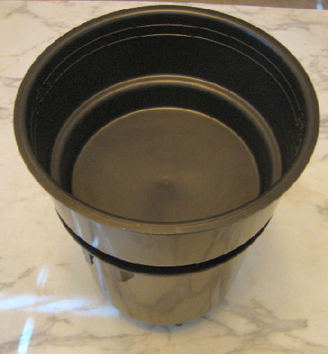 Add the water bowl to the top. A very small hole in the bottom of this bowl allows the water to drip into the bottom bowl without disturbing the coffee.