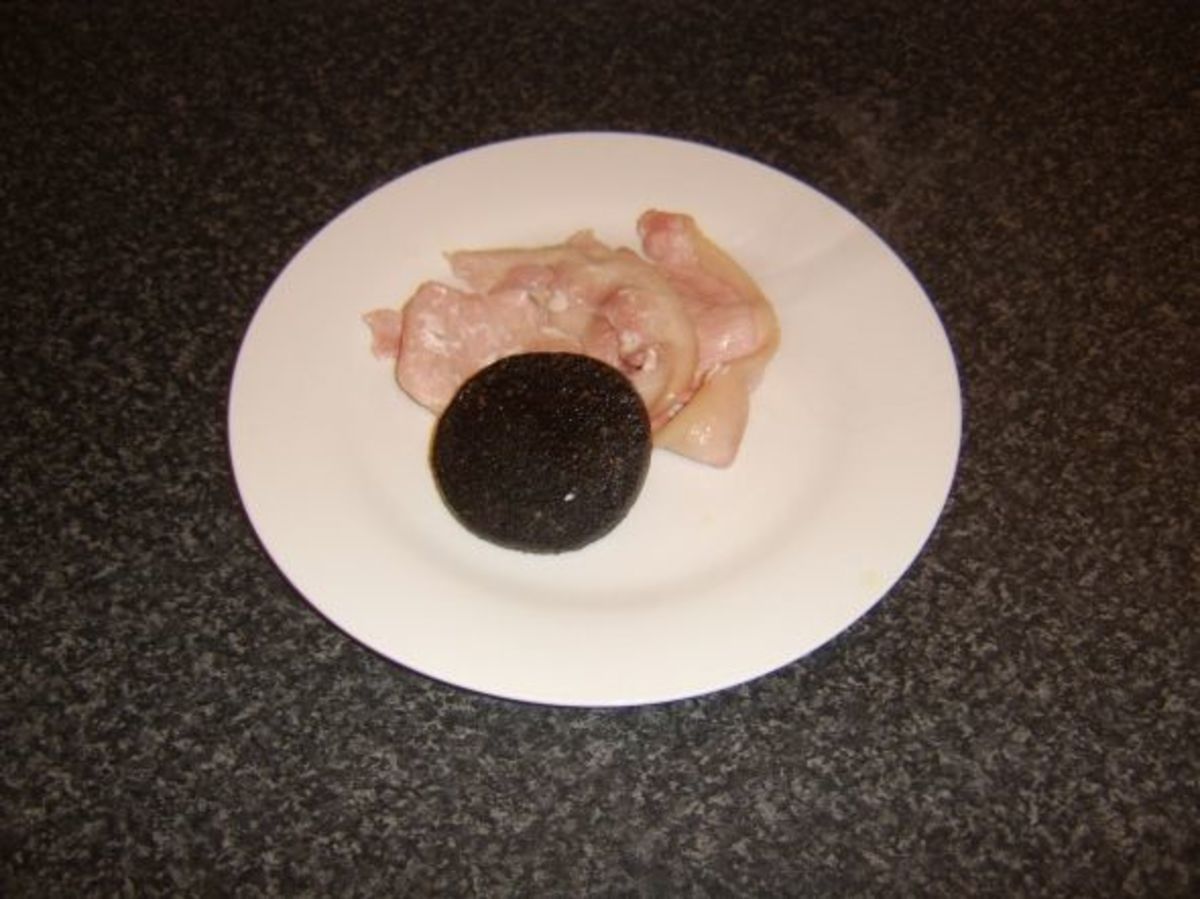 Bacon and black pudding are kept warm on heated plate