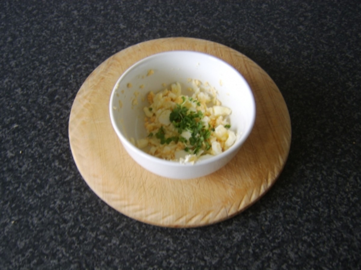 Salad cress is stirred through the mashed egg