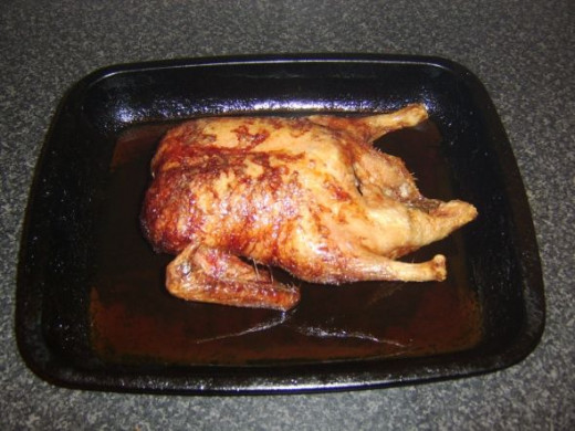 Roast duck is removed from the oven