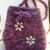 These hobo style purses used 100% wool and have I-cords to carry them around. The same pattern was used to create the black/gray purse, yet each one has a distinct purse-onality. The added bling-bling and appliques made all the difference between cas