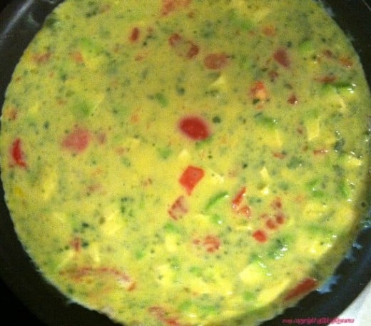 Step 3: Now add the cooked spinach souffle and stir into the mixture so it is evenly distributed. Pour into the skillet so it flows over the water chestnuts.