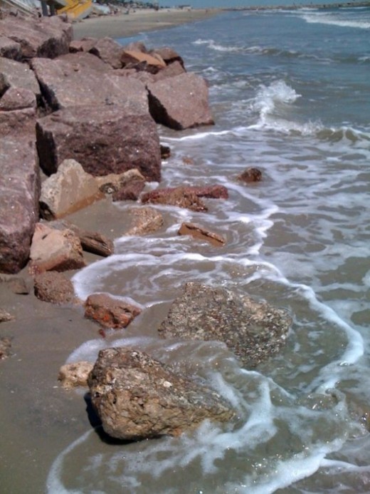 A day spent on Galveston Island's beach with lace waves and rocks.
