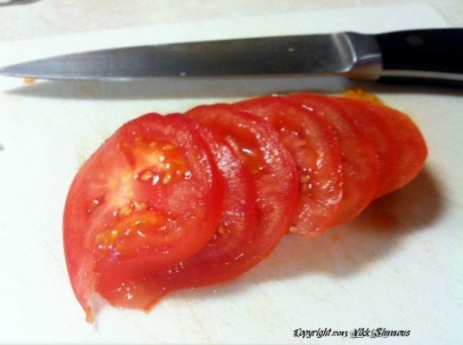 Plump red tomato sliced teases the tongue
