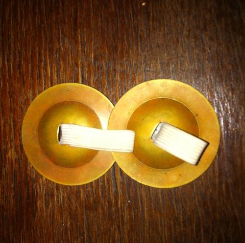 Finger cymbals. Lightly brush one cymbal on top of the other.