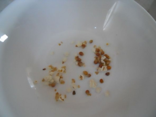 The unpopped kernels will be left at the bottom.