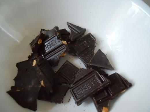 Break chocolate bar into chunks. Microwave for one minute. Check. If not done, repeat.