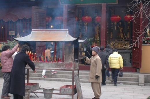 Temples are temples - people come here to light incense to remember their family members who are not with them any more.  This is one activity that happens at both Buddhist and Daoist Temples during New Year's.