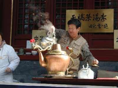 The tea soup seller has a dragon pot which he keeps refilling.  This way you can get the water for your soup poured into your bowl by the dragon!