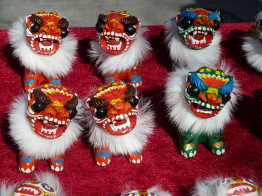 There are lion dogs everywhere. This is not a dragon - it is one of the symbols you see every New Year for sale as toys, danging in performances, and on posters and signs.