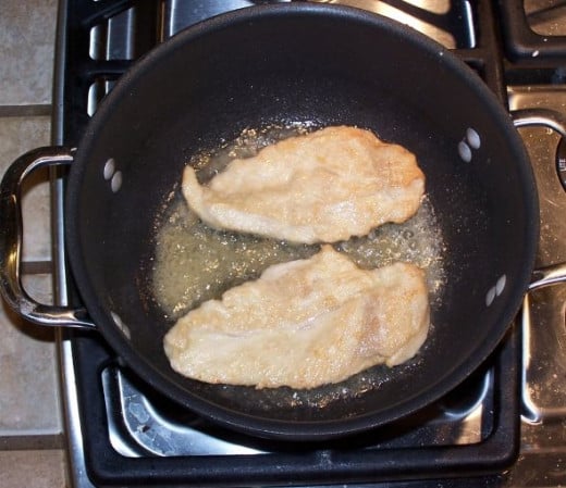 The chicken should be lightly browned in the olive oil. The key word here is "lightly". The majority of the cooking will be done in the oven. After the chicken is a light golden brown, remove it from the oil, and place it on paper towels to drain awa