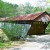 This is a side view of the entrance to the bridge, showing the barricades as well as the new spring leaves still emerging. This is a side view of the entrance to the bridge, showing the barricades as well as the new spring leaves still emerging.