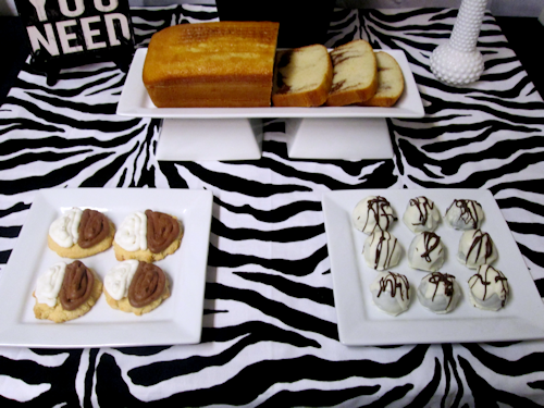 front featurs white marble loaf cake on a double pedestal rectangle platter, 2 square platters with dipped fortune cookies &amp; white chocolate truffles