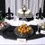 Center -- Elegant Fostoria square cake stand &amp; Maitre'd take residence flanked by 2 fleur de lis, 2 platters on risers, an elegant bowl of muffins.