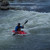 Kayaker playing on the river