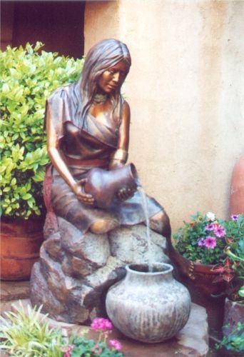 Woman pouring water - fountain.