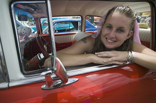 50s costumed girl driving a classic car.