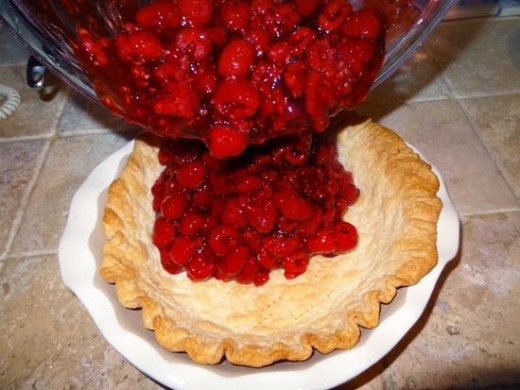 Pour Raspberries and Danish Dessert Pie Glaze into Crust