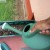 Watering my half-filled (with mud) transplanting container before transplanting seedlings. Watering my half-filled (with mud) transplanting container before transplanting seedlings.