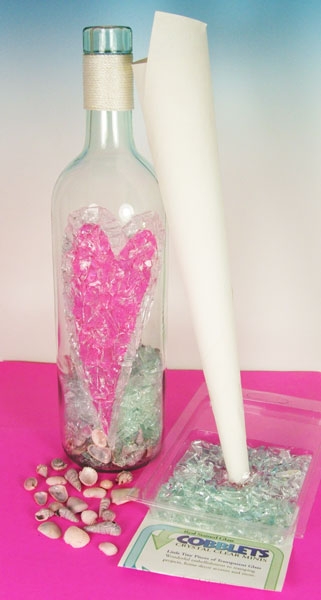 5. To fill your bottle with Glass Cobblets and seashells first make a paper funnel. Using a piece of typing or writing paper roll it into a cone shape making sure that one end is a small enough diameter to easily fit into the bottles neck while the t