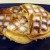 Lift waffles out of the waffle iron and cut into triangles. Use a butter knife to spread the frosting that comes in the cinnamon roll can on top.