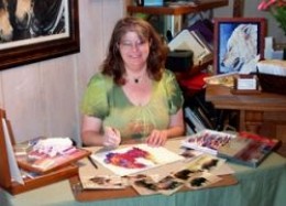 Mona Majorowicz demonstrating oil pastels at a gallery reception