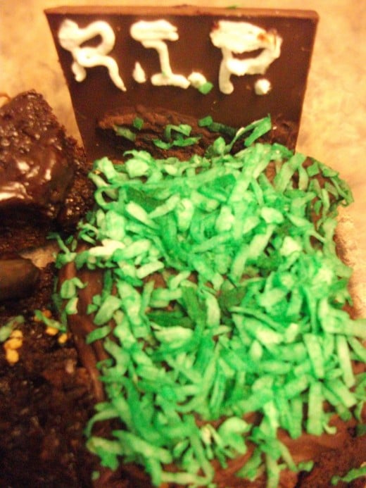 Grave Cake with green food coloring coconut grass