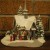 A Thomas Kinkade snow-covered church displaying The Nativity out front A Thomas Kinkade snow-covered church displaying The Nativity out front