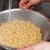 If the macaroni is done, turn off the burner.Put on oven mitts to take the pot to the colander in the sink for draining.Rinse well. Pour the rinsed, drained macaroni into a large salad bowl, then set aside.